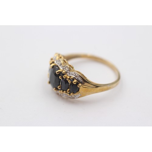 1045 - A 9ct gold sapphire five stone ring with diamond surround - approx. gross weight 4.1 grams