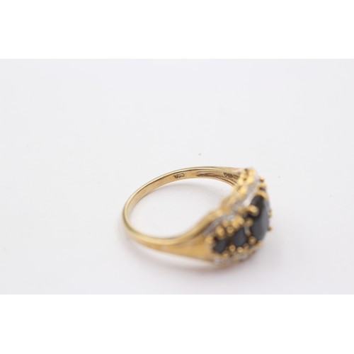 1045 - A 9ct gold sapphire five stone ring with diamond surround - approx. gross weight 4.1 grams