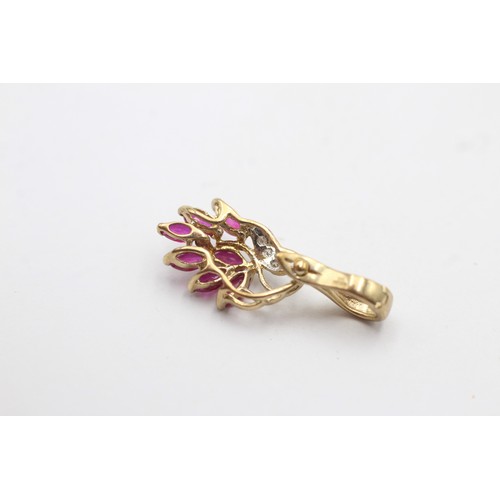 1047 - A 9ct gold diamond and ruby pendant - approx. gross weight 1.3 grams