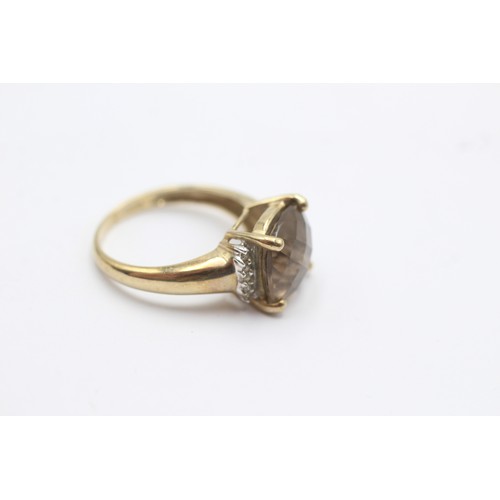 1053 - A 9ct gold smoky quartz single stone ring with diamond accents - approx. gross weight 2.8 grams