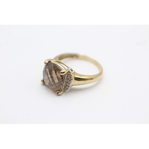 1053 - A 9ct gold smoky quartz single stone ring with diamond accents - approx. gross weight 2.8 grams