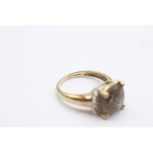 1053 - A 9ct gold smoky quartz single stone ring with diamond accents - approx. gross weight 2.8 grams