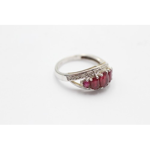 1059 - A 9ct white gold ruby five stone ring with diamond surround - approx. gross weight 2.5 grams