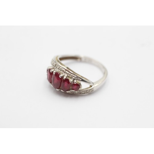 1059 - A 9ct white gold ruby five stone ring with diamond surround - approx. gross weight 2.5 grams