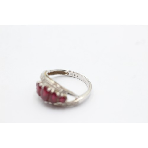 1059 - A 9ct white gold ruby five stone ring with diamond surround - approx. gross weight 2.5 grams