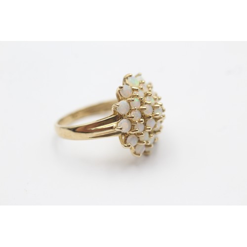 1062 - A 9ct gold opal halo ring, size L½ - approx. gross weight 3.3 grams