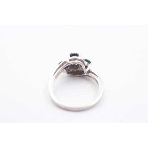 1067 - A 9ct white gold sapphire three stone ring with diamond set shank - approx. gross weight 2.3 grams