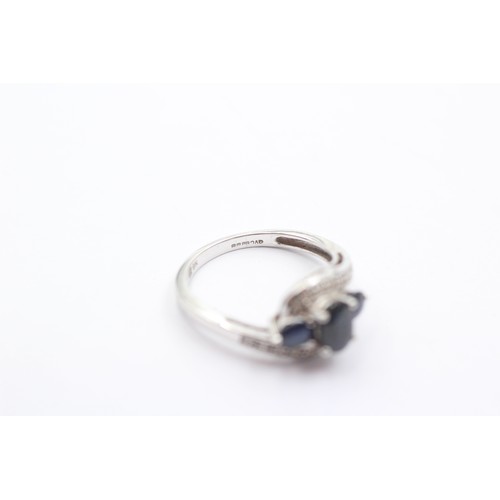 1067 - A 9ct white gold sapphire three stone ring with diamond set shank - approx. gross weight 2.3 grams