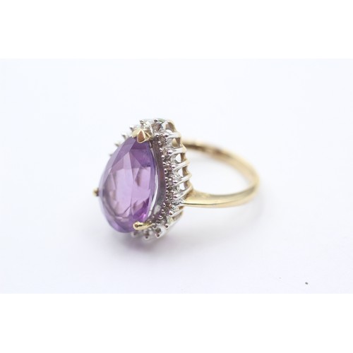 1071 - A 9ct gold amethyst single stone ring with diamond surround - approx. gross weight 4.4 grams