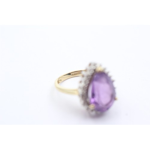 1071 - A 9ct gold amethyst single stone ring with diamond surround - approx. gross weight 4.4 grams