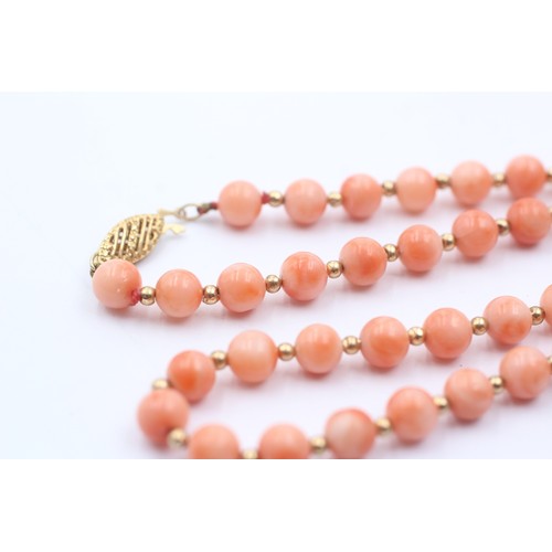 1099 - A coral single strand necklace with 14ct gold clasp and spacers - approx. gross weight 16.7 grams