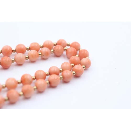 1099 - A coral single strand necklace with 14ct gold clasp and spacers - approx. gross weight 16.7 grams