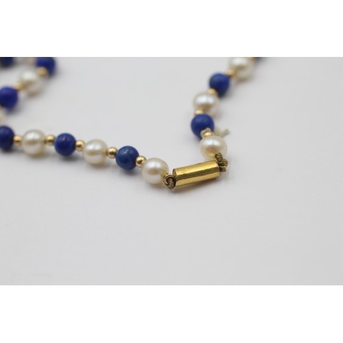 1111 - A cultured pearl and lapis lazuli necklace with 9ct gold clasp and spacers - approx. gross weight 8.... 