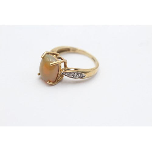 1128 - A 9ct gold opal single stone ring with white gemstone set shank - approx. gross weight 3.1 grams