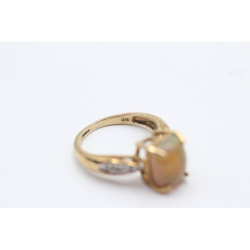 1128 - A 9ct gold opal single stone ring with white gemstone set shank - approx. gross weight 3.1 grams