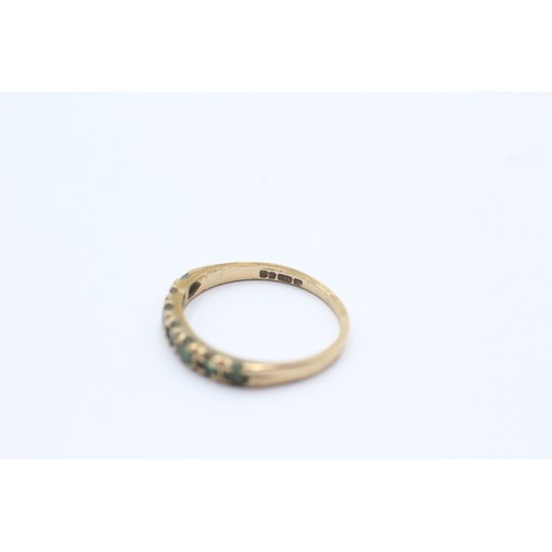 1141 - A 9ct gold emerald half eternity ring - approx. gross weight 1.4 grams