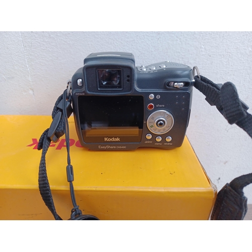 555 - A boxed Kodak EasyShare DX6490 digital camera with software disc, chargers and instruction manual