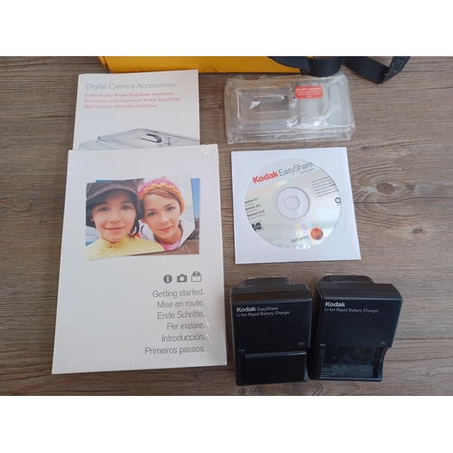 555 - A boxed Kodak EasyShare DX6490 digital camera with software disc, chargers and instruction manual