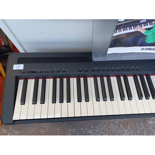 656 - A Yamaha P-95 digital piano with power adaptor, sustain pedal and instruction manual