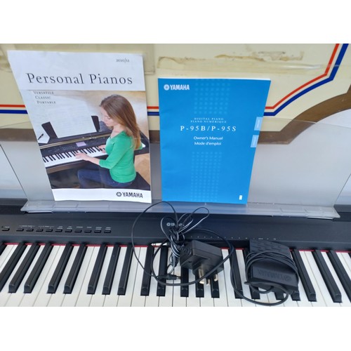 656 - A Yamaha P-95 digital piano with power adaptor, sustain pedal and instruction manual