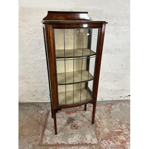 98 - An Edwardian inlaid mahogany display cabinet with single leaded glass door and tapering supports