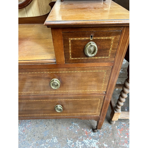 117 - An Edwardian inlaid mahogany dressing table with six drawers, shield shaped mirror and tapering supp... 