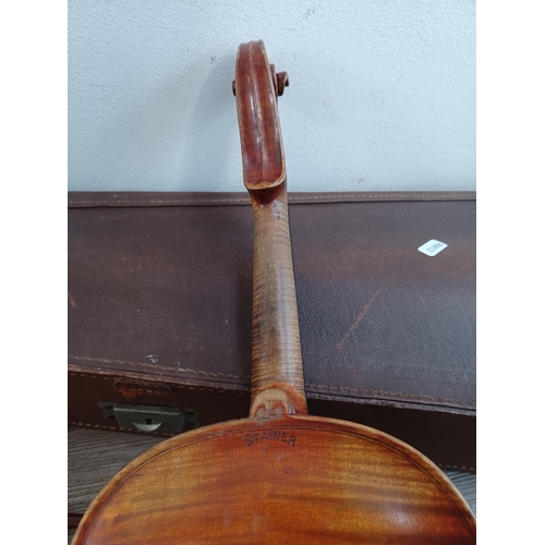 666 - A cased antique violin stamped Stainer to back with bow, tail piece and bridge