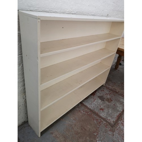 125 - A mid 20th century white painted four tier free standing bookcase - approx. 123cm high x 153cm wide ... 