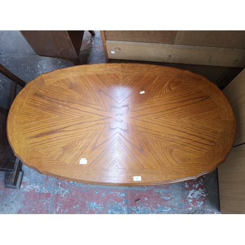 148 - A French style oak parquet top oval pedestal coffee table