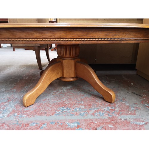 148 - A French style oak parquet top oval pedestal coffee table