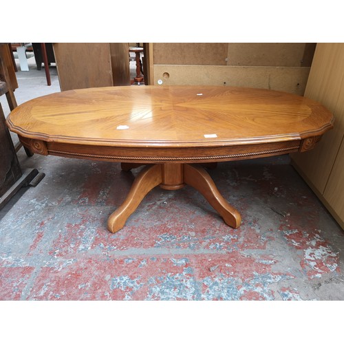 148 - A French style oak parquet top oval pedestal coffee table