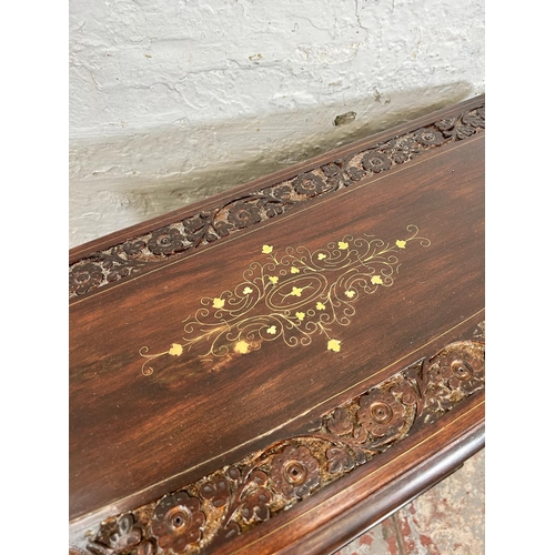 194 - An Indian brass inlaid and carved hardwood two tier open bookcase with two drawers