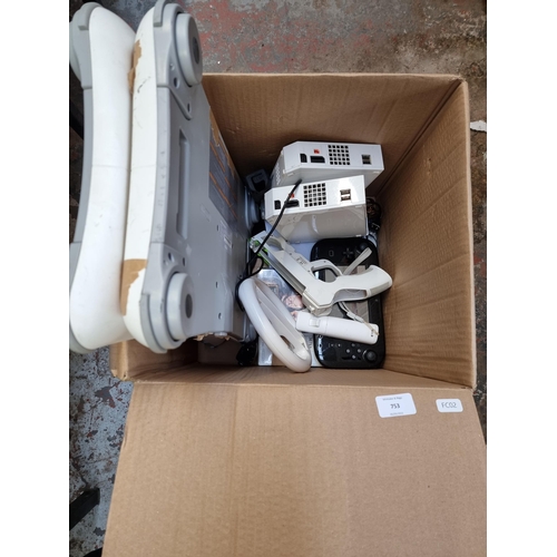 753 - A box containing Nintendo Wii consoles and accessories