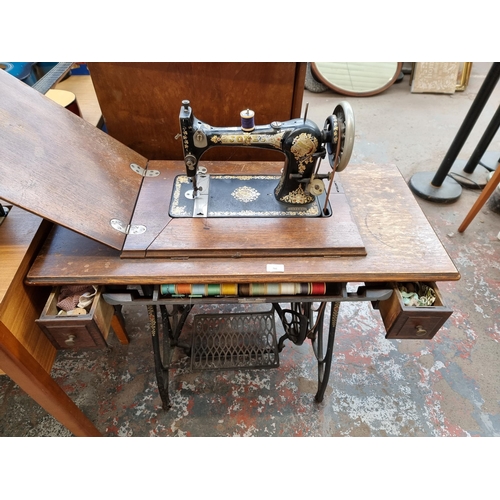 760 - A Jones Medium C.S treadle sewing machine with accessories