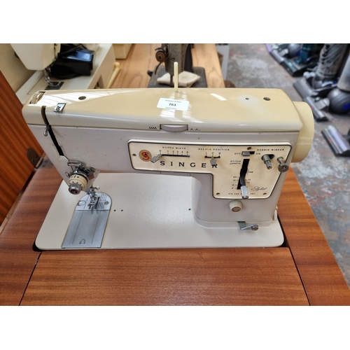 761 - A sewing cabinet containing Singer Zig-Zag model 457 electric sewing machine with foot pedal