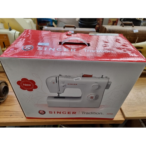 767 - A boxed Singer Tradition 2250 nine stitch electric sewing machine