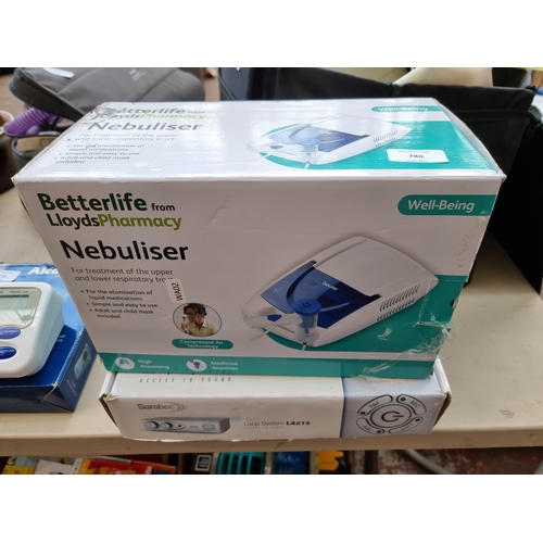 780 - Two boxed items, one Lloyds Pharmacy Nebuliser and one Sarabec LA215 hearing aid loop system