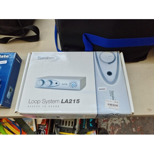 780 - Two boxed items, one Lloyds Pharmacy Nebuliser and one Sarabec LA215 hearing aid loop system