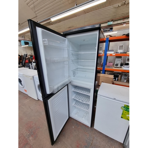 803 - Two items, one Candy upright fridge freezer approx. 174cm high and one Brabantia ironing board