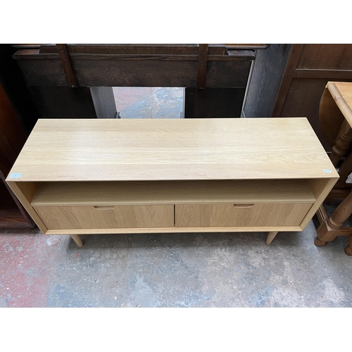 18 - A Scandinavian style oak TV stand with two drawers - approx. 58cm high x 122cm wide x 37cm deep