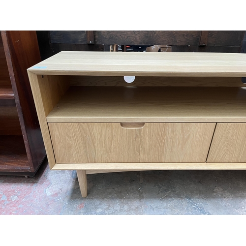 18 - A Scandinavian style oak TV stand with two drawers - approx. 58cm high x 122cm wide x 37cm deep