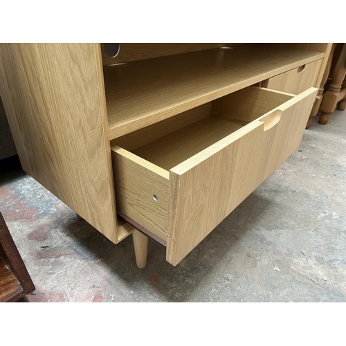 18 - A Scandinavian style oak TV stand with two drawers - approx. 58cm high x 122cm wide x 37cm deep