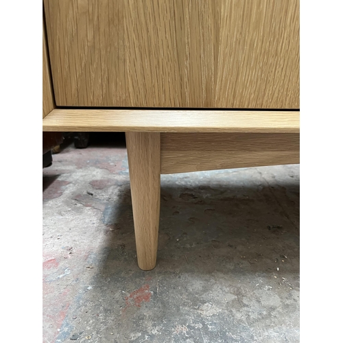 18 - A Scandinavian style oak TV stand with two drawers - approx. 58cm high x 122cm wide x 37cm deep