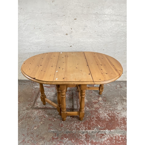 19 - A modern pine drop leaf gate leg oval dining table