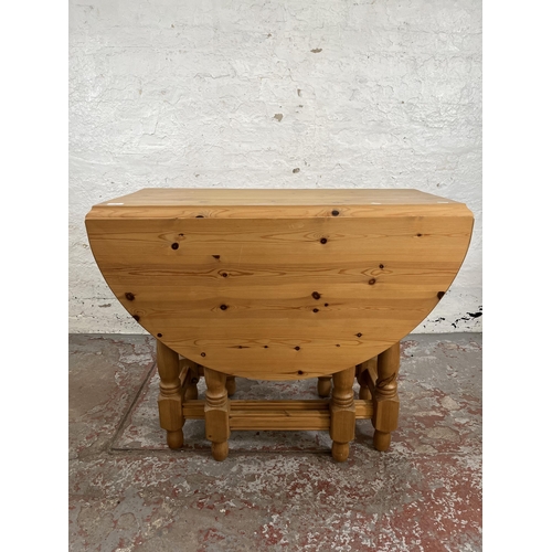 19 - A modern pine drop leaf gate leg oval dining table