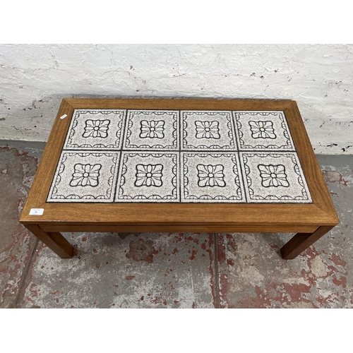 21 - A teak tile top rectangular coffee table