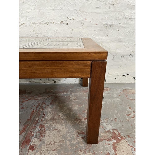 21 - A teak tile top rectangular coffee table