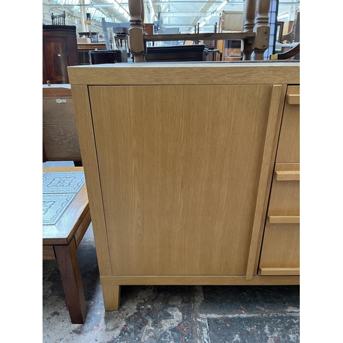 23 - A modern oak sideboard with three central drawers and two outer cupboard doors - approx. 79.5cm high... 