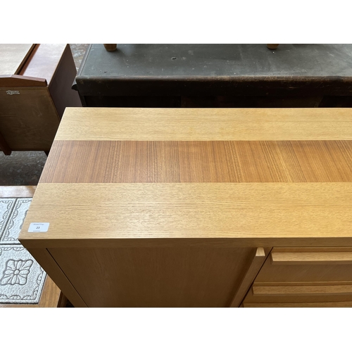 23 - A modern oak sideboard with three central drawers and two outer cupboard doors - approx. 79.5cm high... 