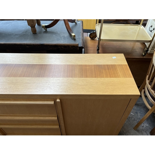 23 - A modern oak sideboard with three central drawers and two outer cupboard doors - approx. 79.5cm high... 